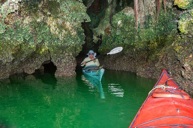 Visitors kayaking through sea caves and hidden lagoons during an adventure-filled James Bond Tour.