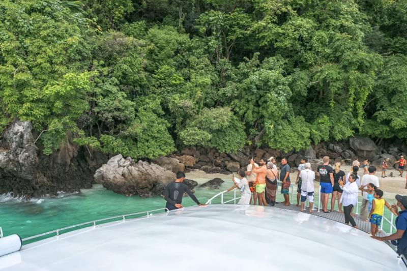 Tourists enjoying their Phi Phi Island Tour with stunning tropical landscapes and crystal-clear wate