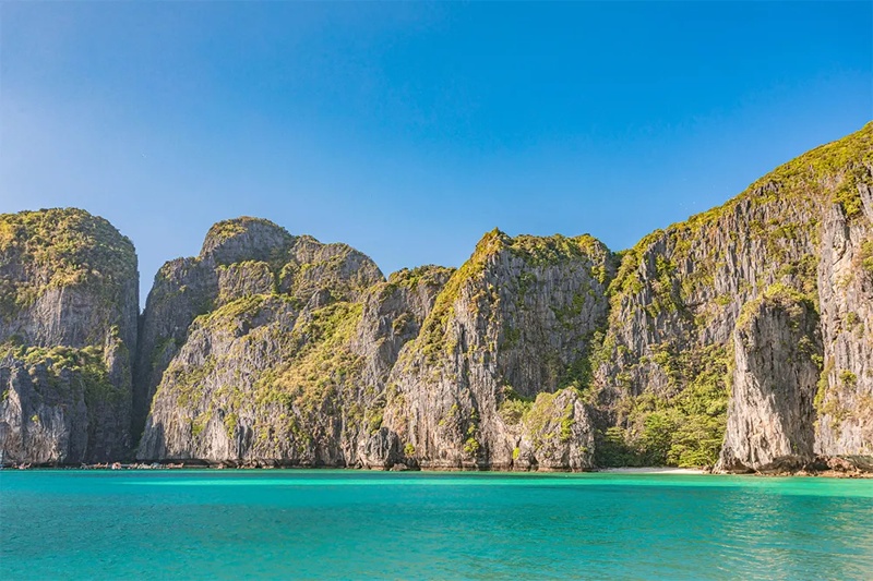 Clear water around Koh Bamboo Island in Phi Phi Islands, showcasing the beauty of the natural surrou