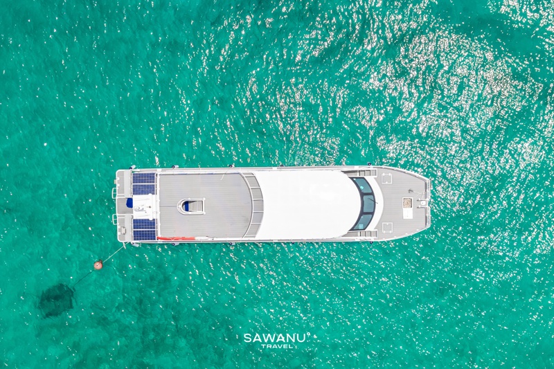Catamaran on a Phi Phi Islands beach, with stunning limestone cliffs in the background.