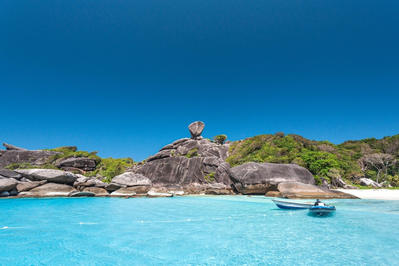 Visitors enjoying a snorkeling tour in the vibrant blue waters of Similan Islands.
