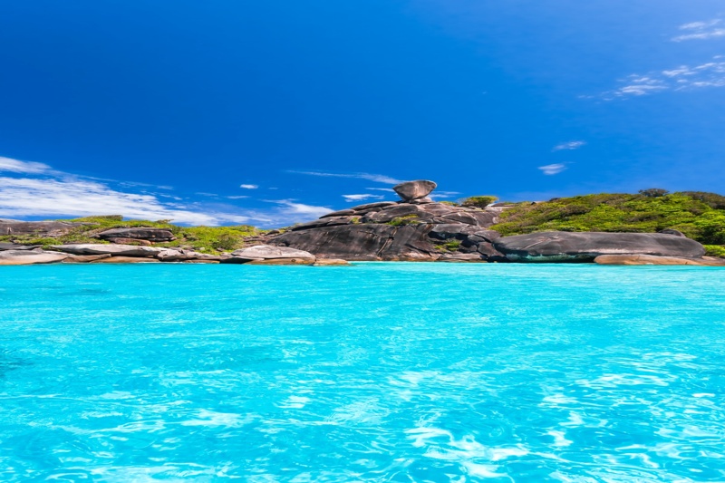 Tropical paradise at Similan Islands with lush greenery and crystal clear water.