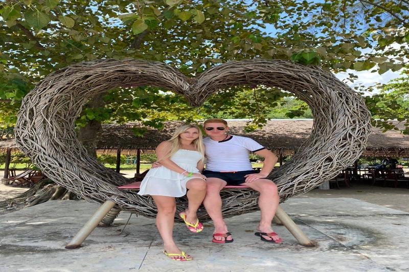 Capture the perfect romantic moment on a heart-shaped swing in Thailand, offering a beautiful backdr