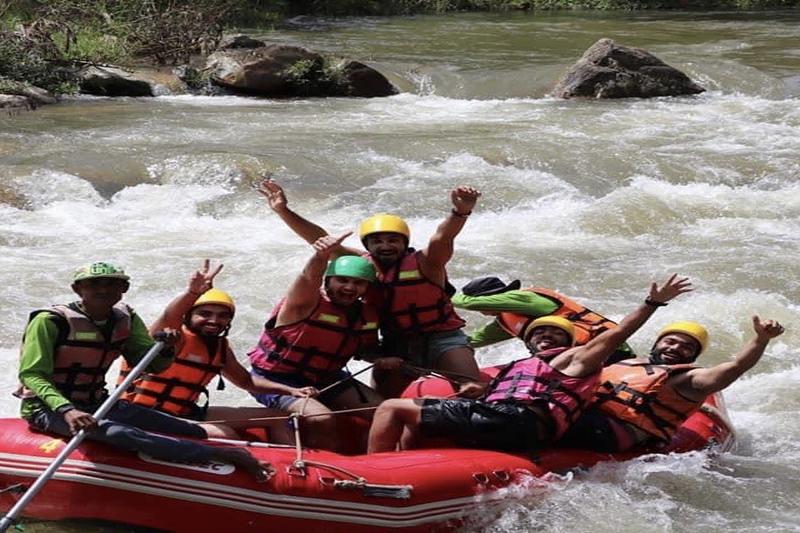 Enjoy rafting with friends on a scenic river, navigating rapids together.