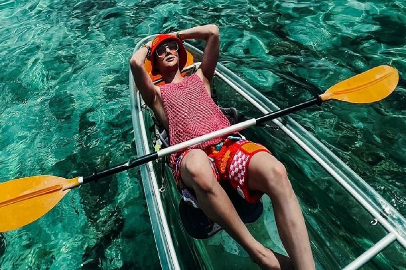 Enjoy kayaking on clear, serene waters with friends for a fun outdoor adventure.