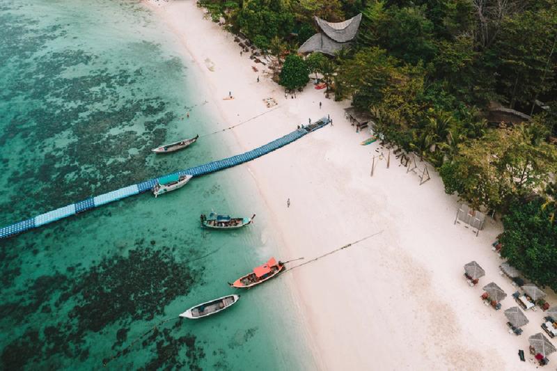 Explore a boat pier stretching over clear, calm waters for a scenic adventure.