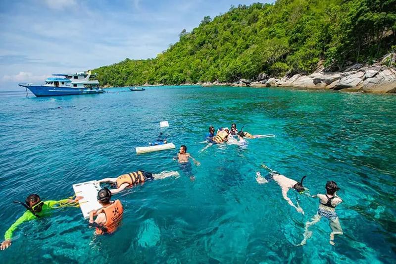 Snorkelers enjoying a boat ride at Koh Racha Yai Island, preparing for a snorkeling adventure.