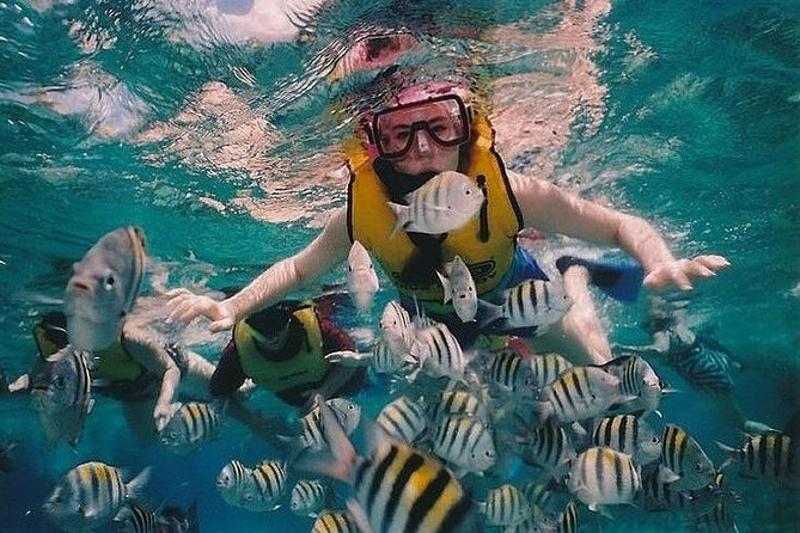 Snorkelers aboard a boat, heading to a beautiful snorkeling spot at Koh Racha Yai Island.