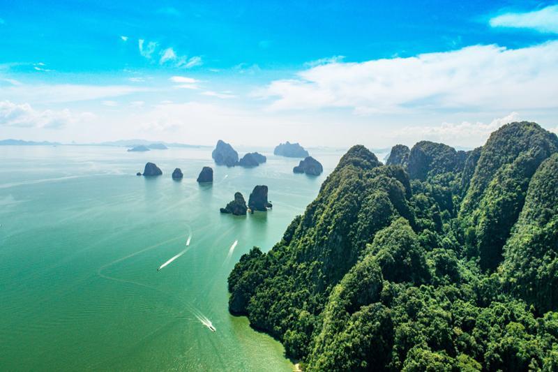Enjoy a beautiful day on Koh Hong Island, Thailand, with clear waters, lush greenery, and an idyllic