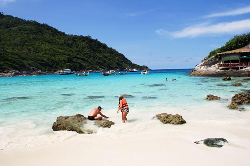 Enjoy a relaxing time on Coral Island in Phuket with calm turquoise waters, sandy beaches, and a pea