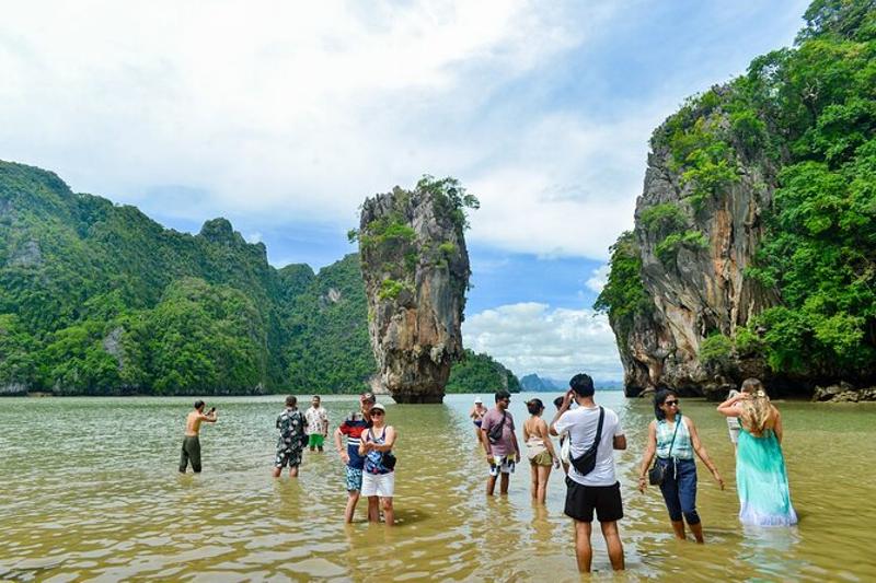 Tourists enjoying the scenic views at James Bond Island in Phuket, Thailand.