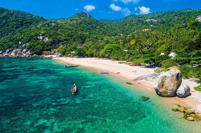 Stunning aerial view of Tanote Bay, Koh Tao, known for its clear blue water and rocky surroundings.