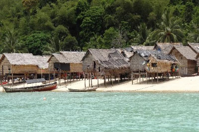 Moken village at the Surin Islands, home to the Moken people, with traditional huts by the water.