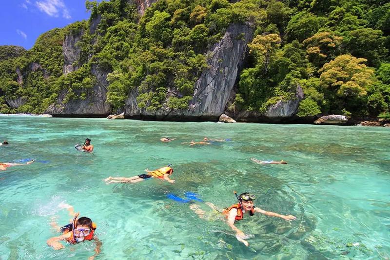 Snorkeling in the clear waters of a beautiful Thai island, with colorful fish and vibrant coral reef