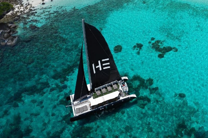 A picturesque beach in Thailand with a long wooden pier leading to the clear turquoise waters.
