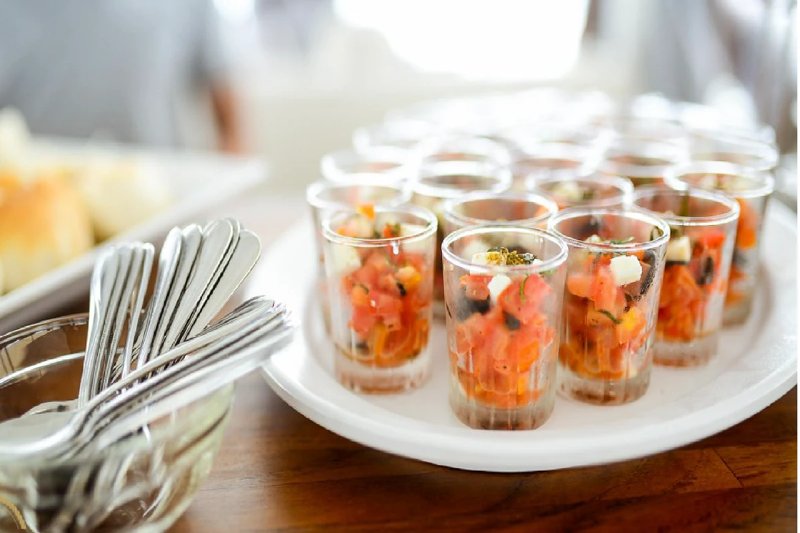 An elegant display of appetizers served in glass cups on a luxury yacht for a sophisticated dining e