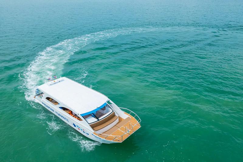 A James Bond-style speed catamaran called Andaman Surprise cruising through the turquoise waters of 