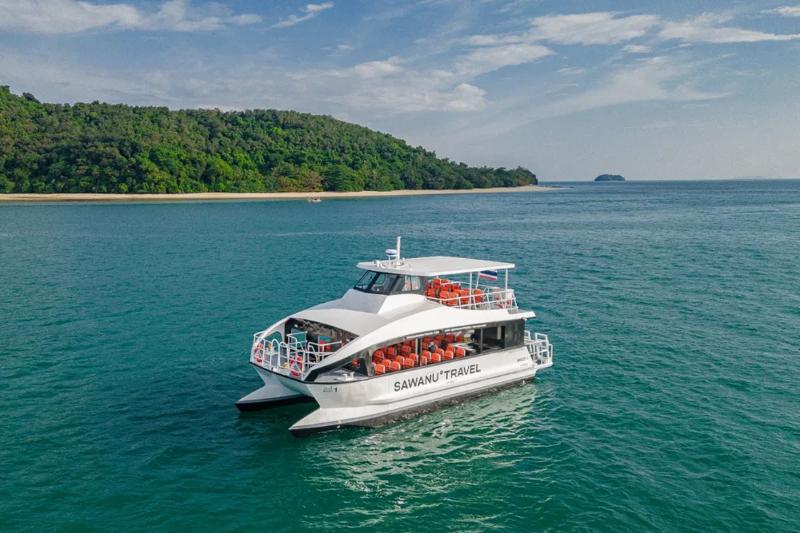 Sawanu luxury yacht cruising through calm blue waters, with orange life jackets visible on the upper