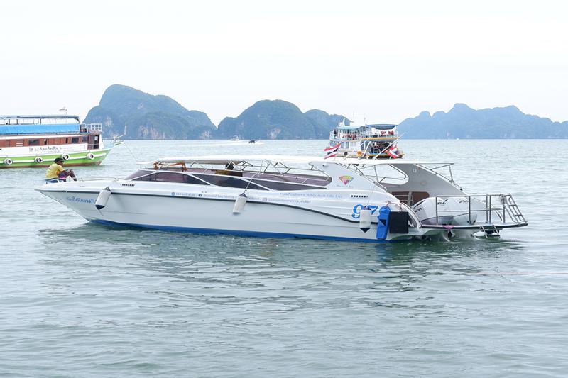 Private premium speedboat on a James Bond tour in Phuket, Thailand, cruising through clear blue wate