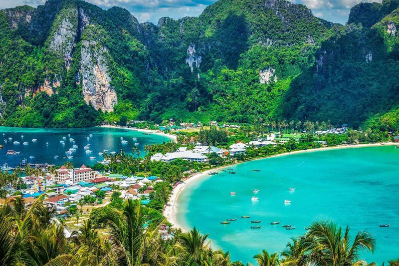 A picturesque view of Phi Phi Island, Thailand, featuring a blend of beaches, boats, and clear turqu