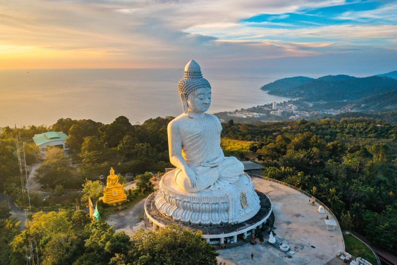 Beautiful sunset view of Big Buddha Phuket overlooking the city with a serene atmosphere at dusk.
