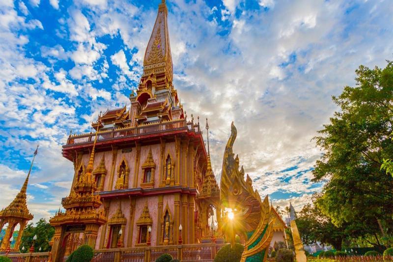 Aerial view of the Big Buddha in Phuket, Thailand, with lush green surroundings and a clear view of 