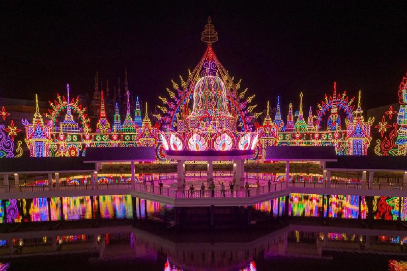 Vibrant light display with reflections in water at night.