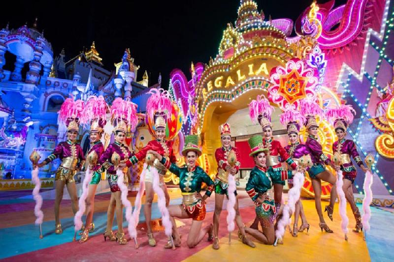 Dancers performing in colorful outfits during a lively carnival parade.