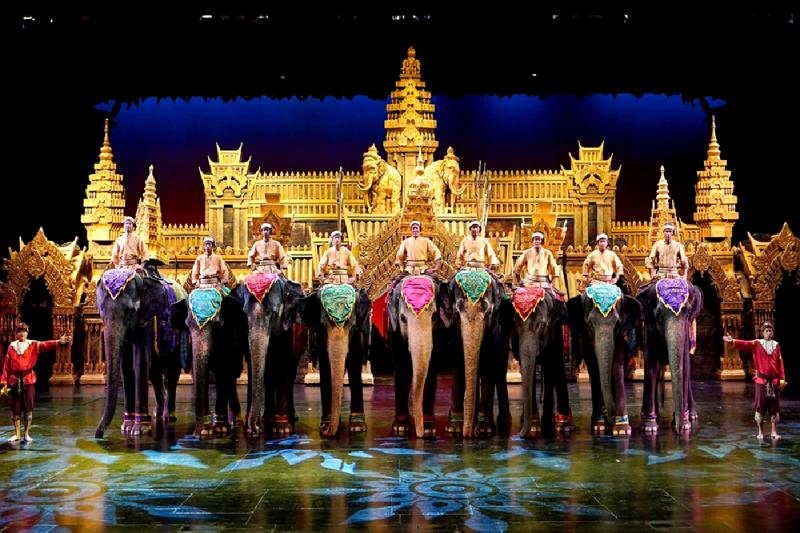 A nighttime parade at Phuket Fantasea, featuring vibrant lights and performers in stunning costumes.