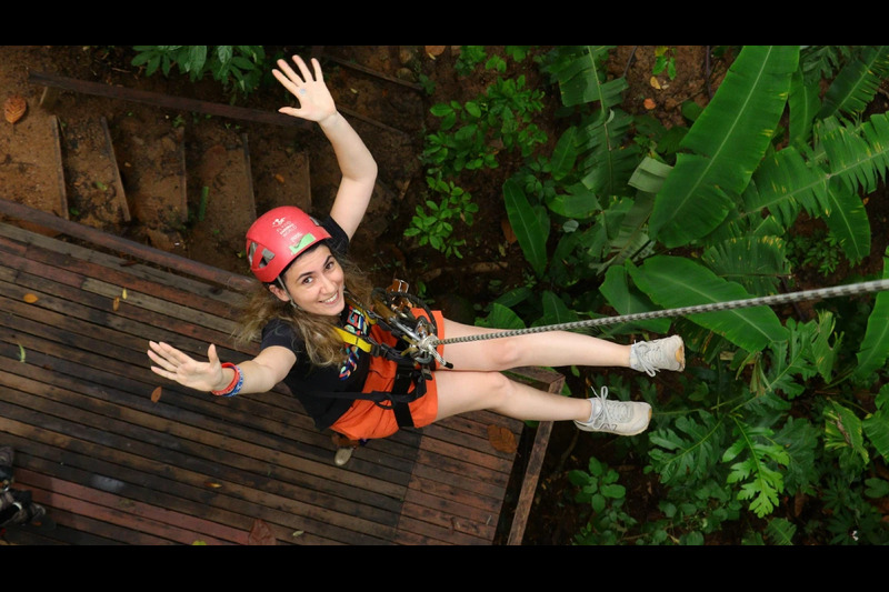 A visitor standing on a tree platform at Hanuman World Phuket, enjoying the peaceful jungle surround