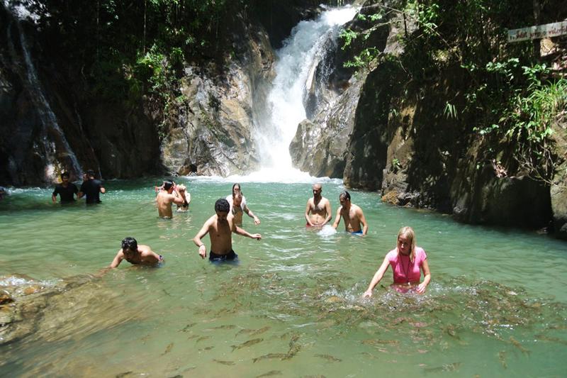 Tourists enjoying rafting adventure at Ton Pariwat Waterfall in Phuket.